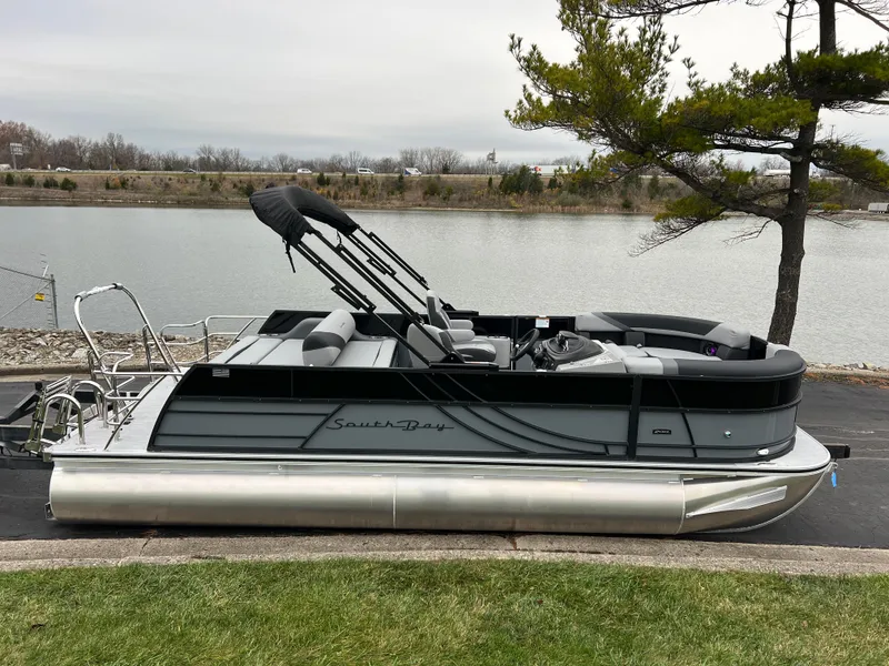 Slide: The Image of 2025 South Bay S222 UL pontoon boat by a serene lake. - 4