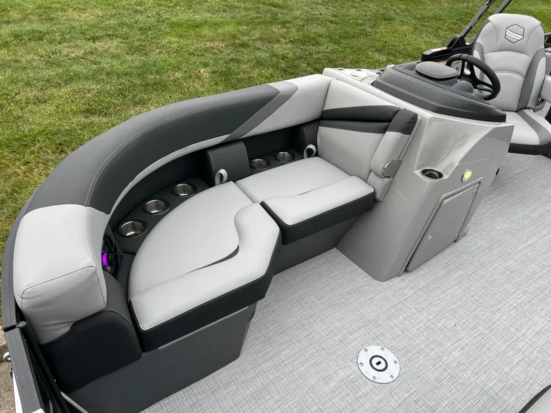 Slide: The Image of 2025 South Bay S222 UL pontoon boat interior with gray seating and cup holders. - 9
