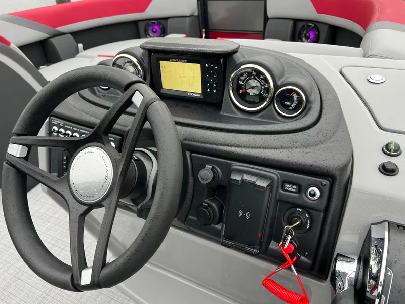 Slide: The Image of 2025 South Bay S222 RS Tri 3.0 boat dashboard with steering wheel and navigation system. - 18