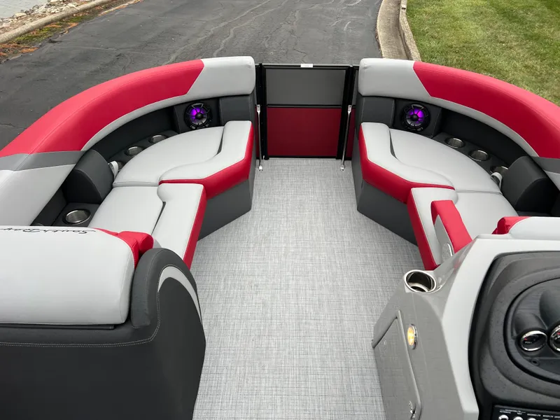 Slide: The Image of 2025 South Bay S222 RS Tri 3.0 pontoon boat interior with red and gray seating. - 19