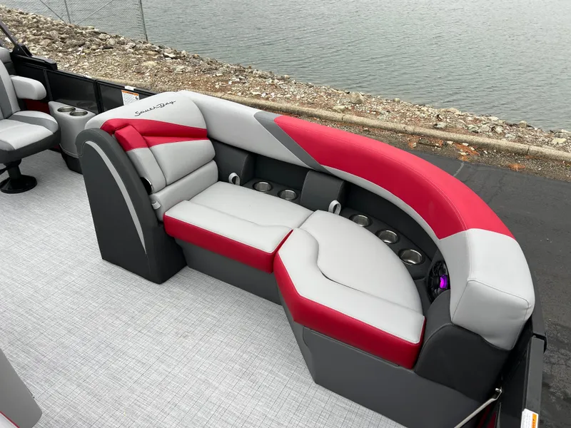 Slide: The Image of 2025 South Bay S222 RS Tri 3.0 boat interior with red and gray seating. - 8