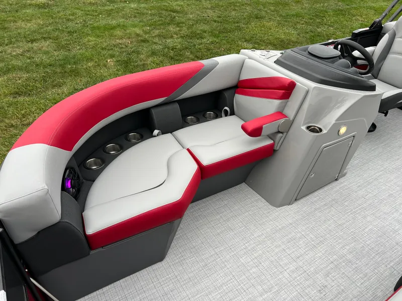 Slide: The Image of 2025 South Bay S222 RS Tri 3.0 boat interior with red and gray seating. - 9