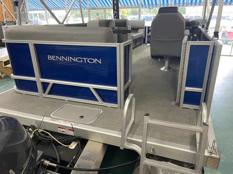Slide: The Image of 2024 Bennington 188SVLSR pontoon boat interior with blue paneling and gray seating. - 14