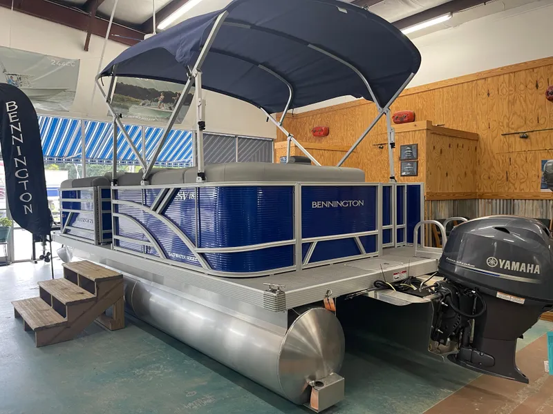 Slide: The Image of 2024 Bennington 188SVLSR pontoon boat with Yamaha outboard motor in showroom. - 16