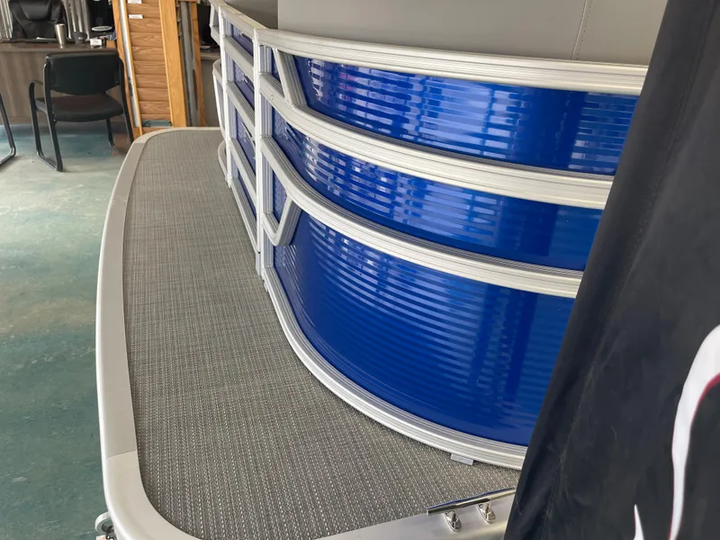 Slide: The Image of 2024 Bennington 188SVLSR pontoon boat with blue paneling and gray flooring. - 21
