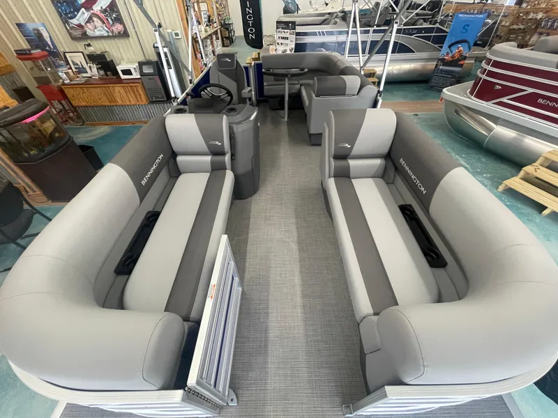 Slide: The Image of 2024 Bennington 188SVLSR pontoon boat interior with gray seating in showroom. - 25