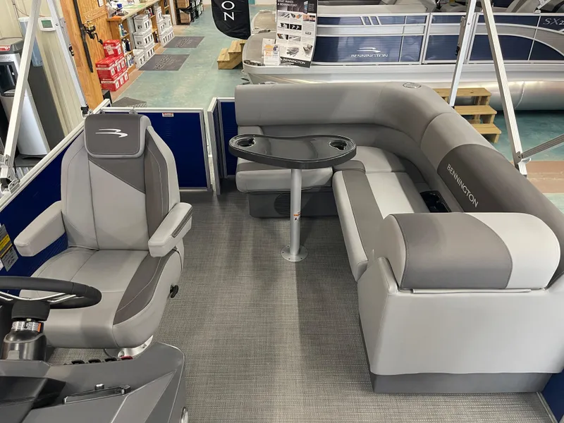 Slide: The Image of 2024 Bennington 188SVLSR pontoon boat interior with gray seating and table. - 28