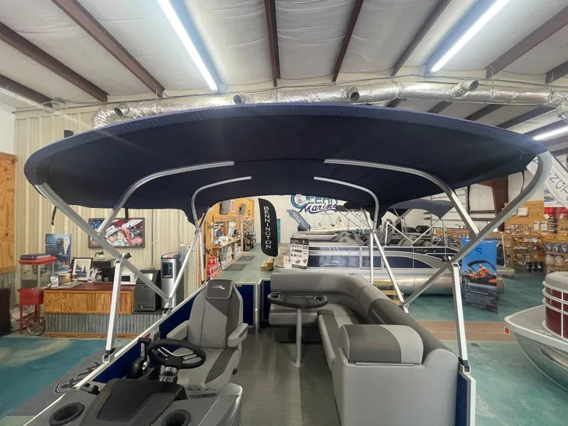 Slide: The Image of 2024 Bennington 188SVLSR pontoon boat with canopy in showroom. - 30
