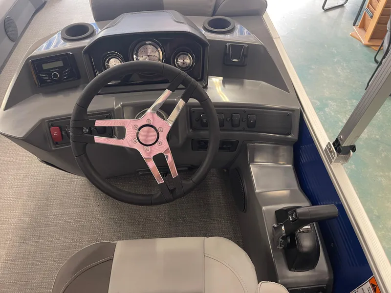 Slide: The Image of 2024 Bennington 188SVLSR boat dashboard with steering wheel and controls. - 34