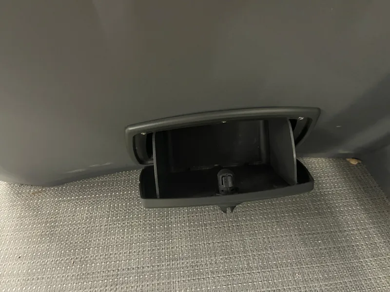 Slide: The Image of 2024 Bennington 188SVLSR storage compartment with USB port on textured flooring. - 47