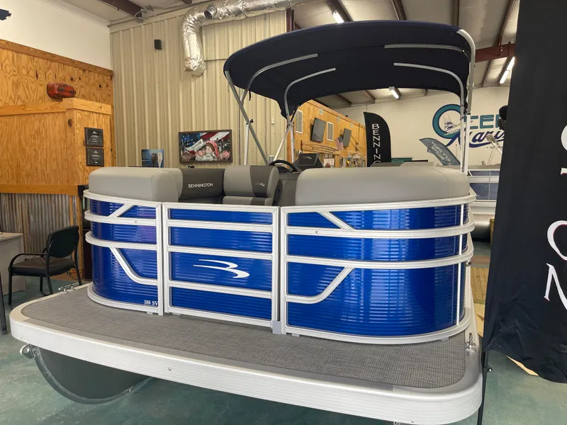 Slide: The Image of 2024 Bennington 188SVLSR pontoon boat with blue exterior in showroom. - 6