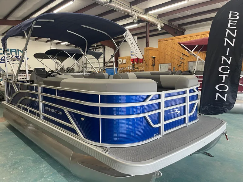 Slide: The Image of 2024 Bennington 188SVLSR pontoon boat with blue exterior in showroom. - 7