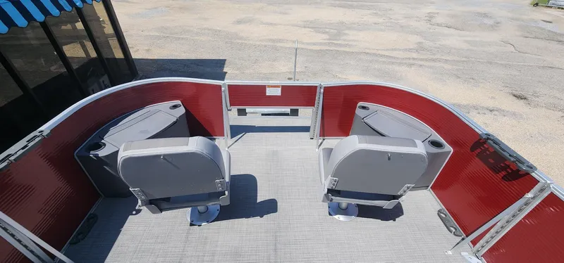 Slide: The Image of 2024 Bennington 20SVFSR pontoon boat interior with red panels and gray seating. - 13