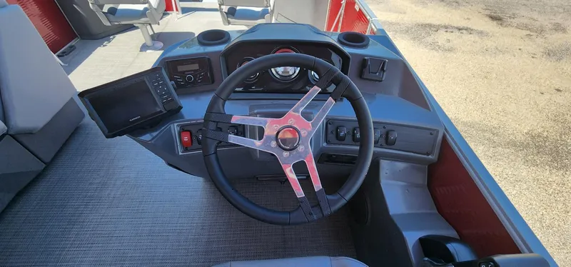 Slide: The Image of 2024 Bennington 20SVFSR boat dashboard with steering wheel and control panel. - 16