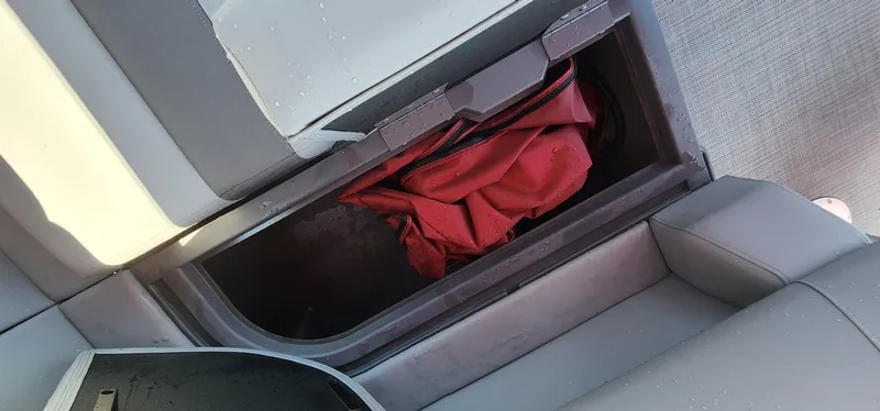 Slide: The Image of Storage compartment in 2024 Bennington 20SVFSR boat with red fabric inside. - 19
