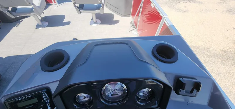 Slide: The Image of 2024 Bennington 20SVFSR boat dashboard with gauges and cup holders. - 27