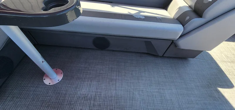 Slide: The Image of 2024 Bennington 20SVFSR boat interior with gray seating and textured flooring. - 29