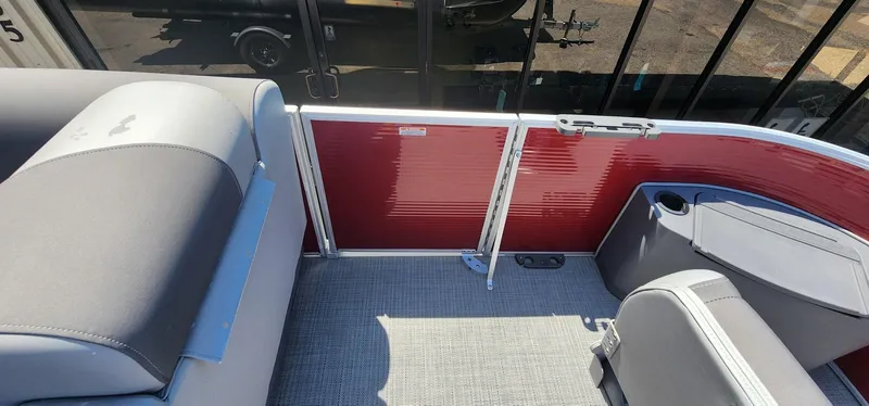 Slide: The Image of 2024 Bennington 20SVFSR pontoon boat interior with red paneling and gray seating. - 34