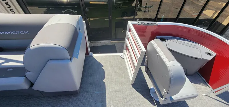 Slide: The Image of 2024 Bennington 20SVFSR pontoon boat interior with gray seating and red accents. - 35