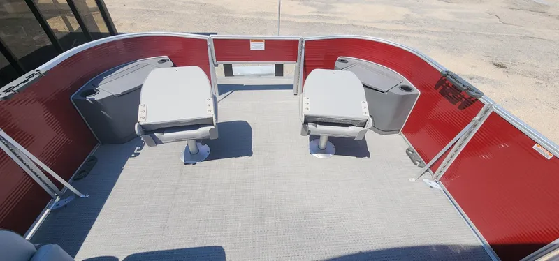 Slide: The Image of 2024 Bennington 20SVFSR pontoon boat interior with red panels and gray seating. - 38