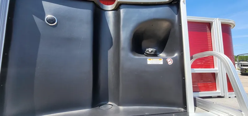 Slide: The Image of 2024 Bennington 20SVFSR boat detail with red paneling and black components. - 42