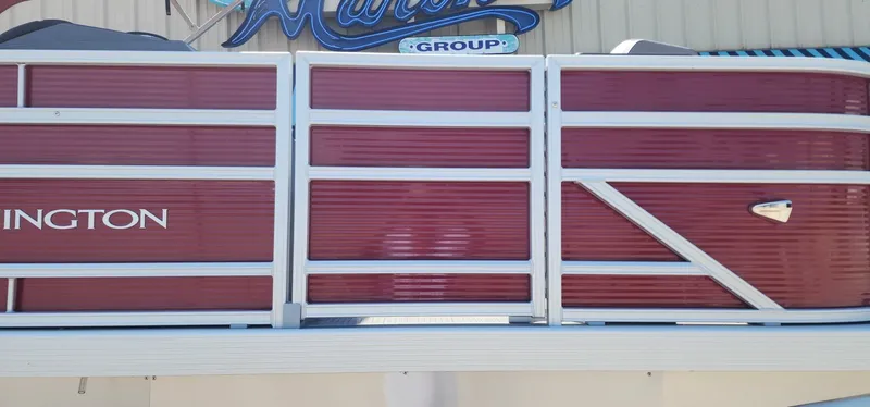 Slide: The Image of 2024 Bennington 20SVFSR pontoon boat with red paneling and white railing. - 9