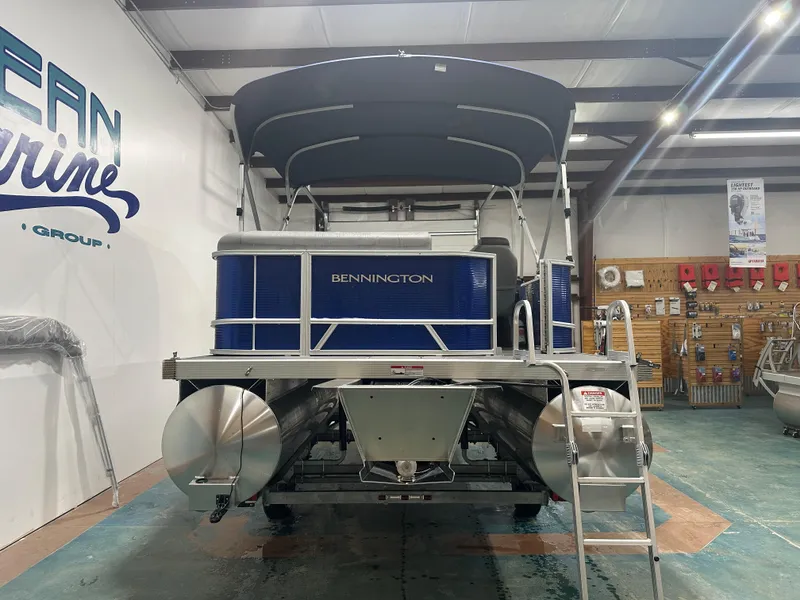 Slide: The Image of 2024 Bennington 20SVLSR pontoon boat in showroom, rear view. - 13