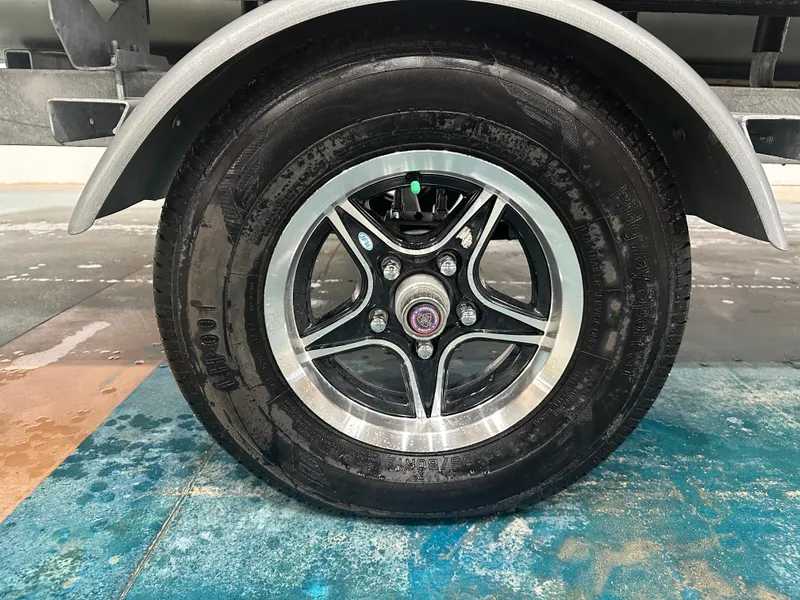 Slide: The Image of 2024 Bennington 20SVLSR trailer wheel with black and silver alloy rim. - 17