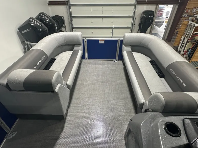 Slide: The Image of 2024 Bennington 20SVLSR pontoon boat interior with gray seating and Mercury engines. - 21