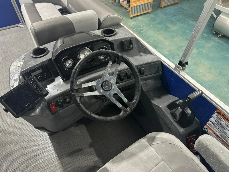 Slide: The Image of 2024 Bennington 20SVLSR boat dashboard with steering wheel and controls. - 27