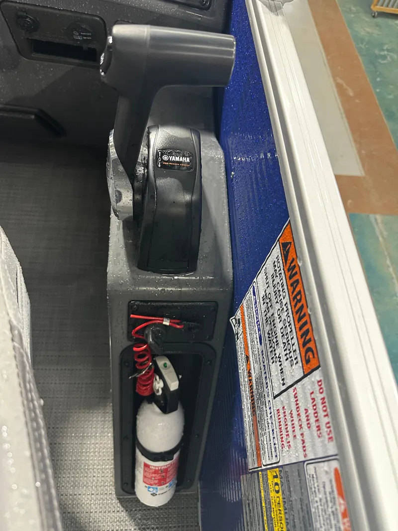Slide: The Image of 2024 Bennington 20SVLSR boat controls with Yamaha throttle and safety equipment. - 35