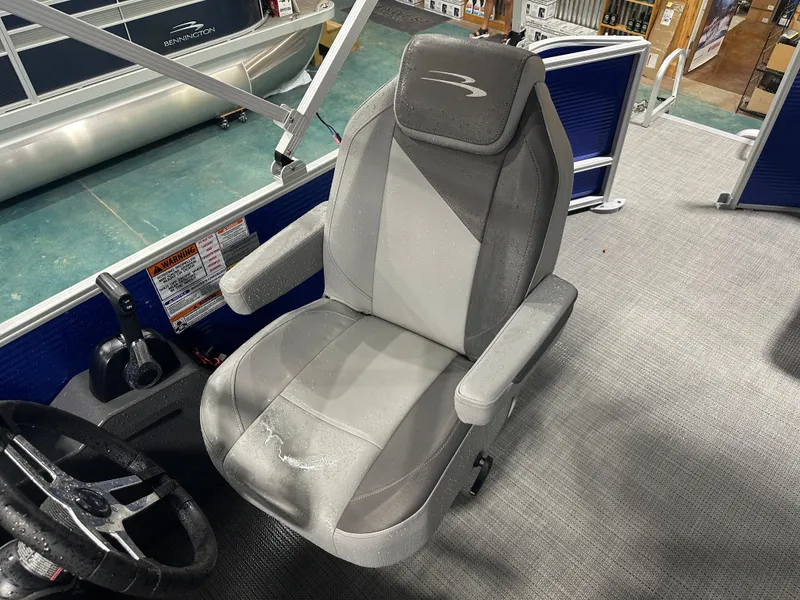 Slide: The Image of 2024 Bennington 20SVLSR boat interior with gray captain's chair and steering wheel. - 36