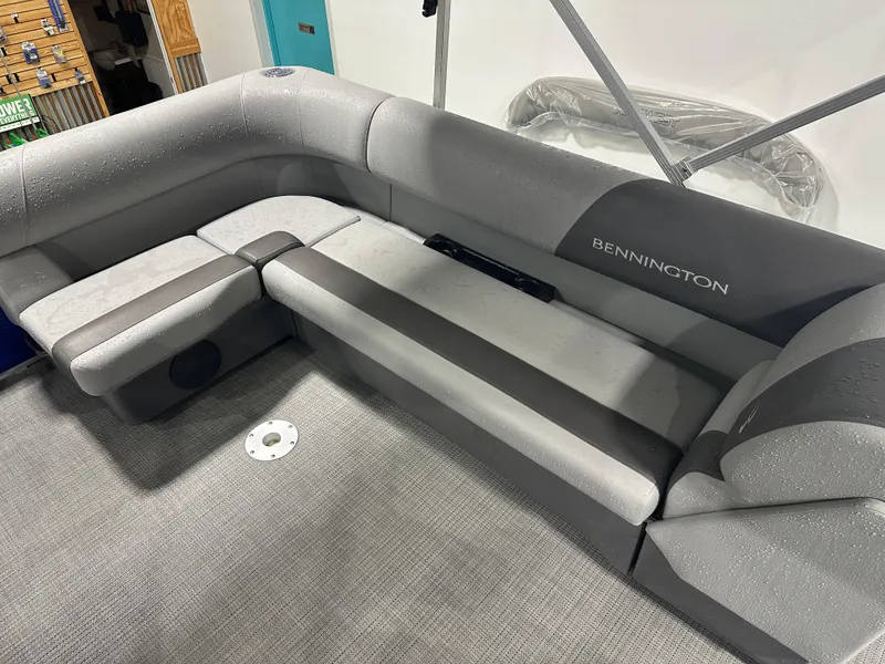 Slide: The Image of 2024 Bennington 20SVLSR boat interior with gray seating and carpeted floor. - 37