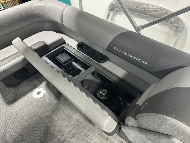 Slide: The Image of 2024 Bennington 20SVLSR boat interior with open storage compartment and seating. - 38