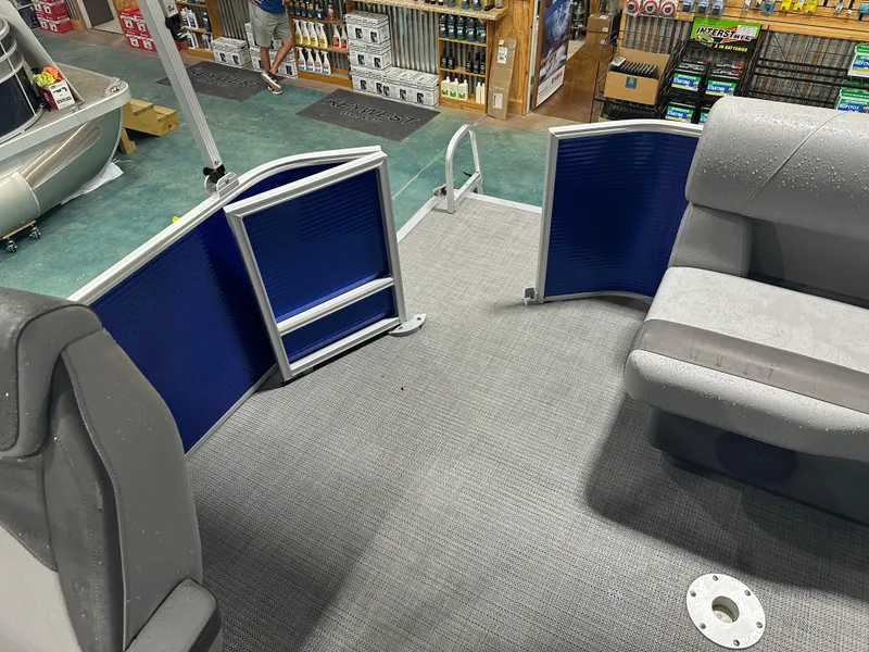 Slide: The Image of 2024 Bennington 20SVLSR pontoon boat interior with gray seating and blue paneling. - 40