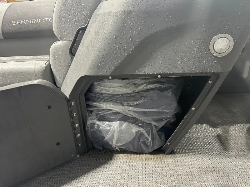 Slide: The Image of 2024 Bennington 20SVLSR boat seat storage with water droplets. - 44