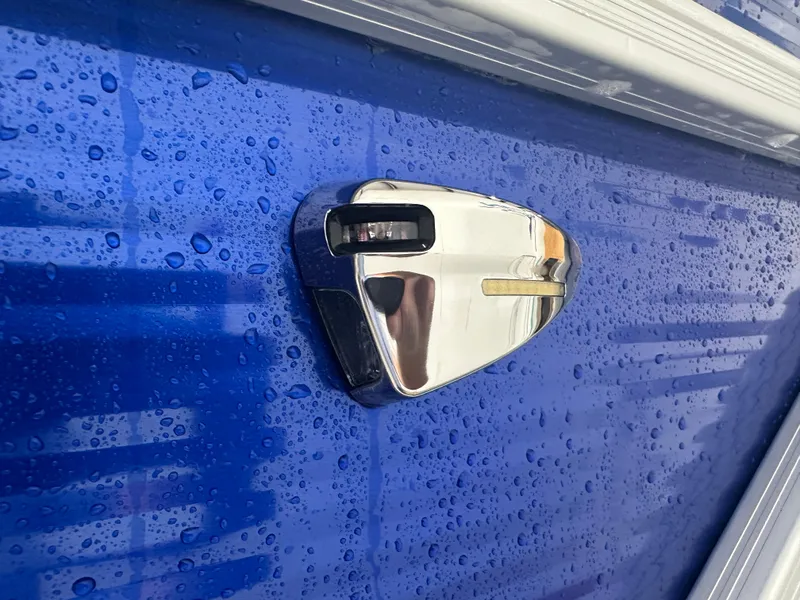 Slide: The Image of Close-up of 2024 Bennington 20SVLSR boat detail with raindrops on blue surface. - 7