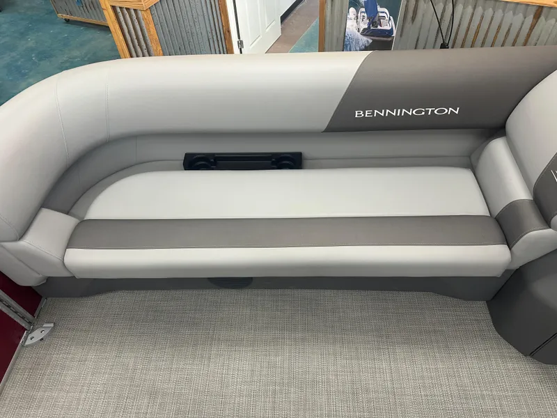 Slide: The Image of 2024 Bennington 20SVLSR boat interior with gray seating and logo. - 14