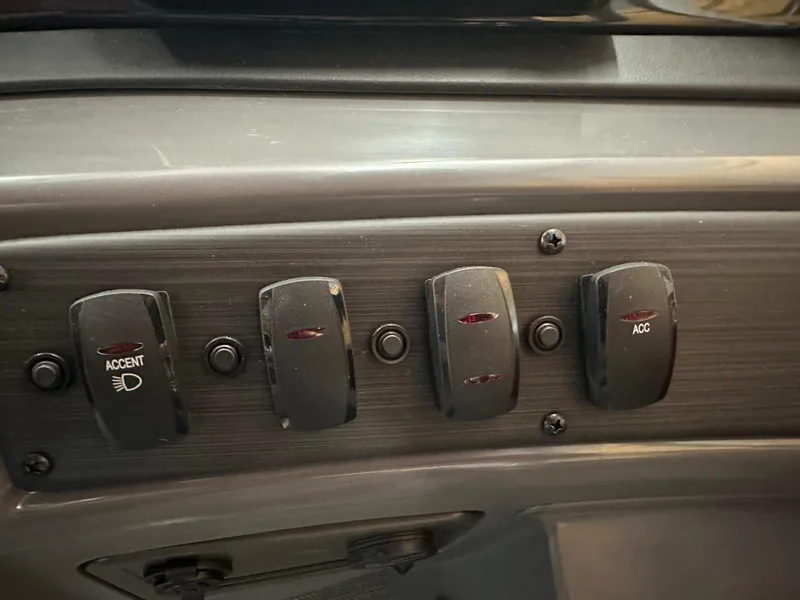 Slide: The Image of Dashboard switches on 2024 Bennington 20SVLSR boat, featuring accent lighting and accessory controls. - 22