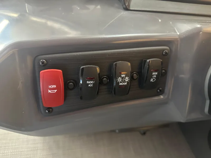 Slide: The Image of 2024 Bennington 20SVLSR boat dashboard switches: horn, radio, navigation, dock lights. - 23
