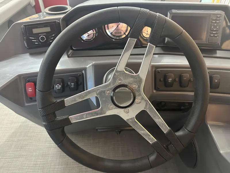 Slide: The Image of 2024 Bennington 20SVLSR boat dashboard with steering wheel and control panel. - 24