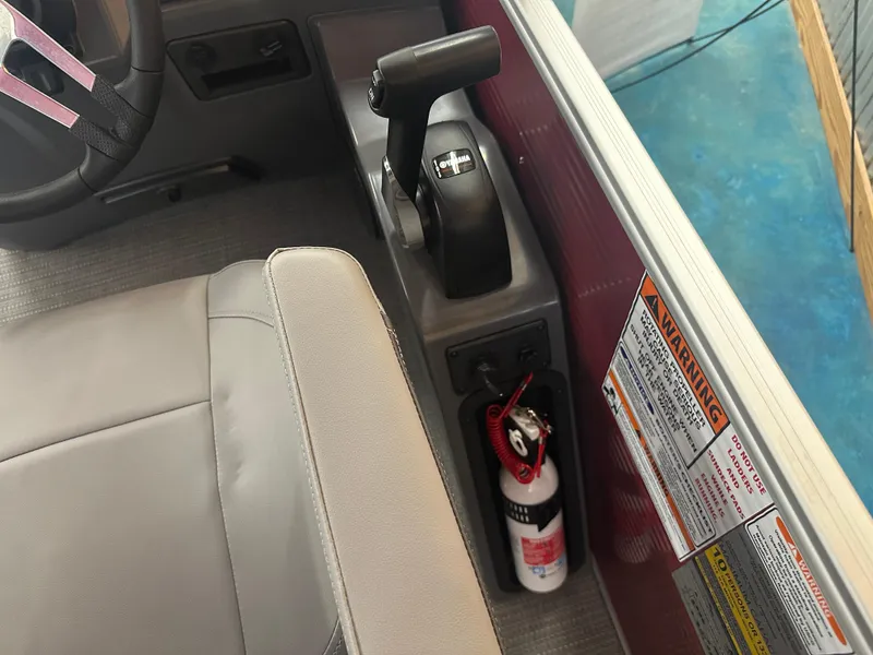 Slide: The Image of 2024 Bennington 20SVLSR boat interior with steering wheel, throttle, and safety warnings. - 25