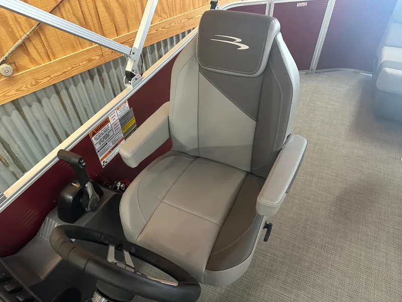 Slide: The Image of 2024 Bennington 20SVLSR boat captain's chair with steering wheel and controls. - 26