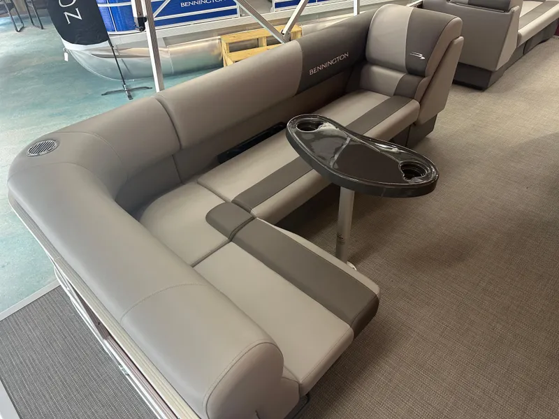 Slide: The Image of 2024 Bennington 20SVLSR boat interior with gray seating and a black table. - 27