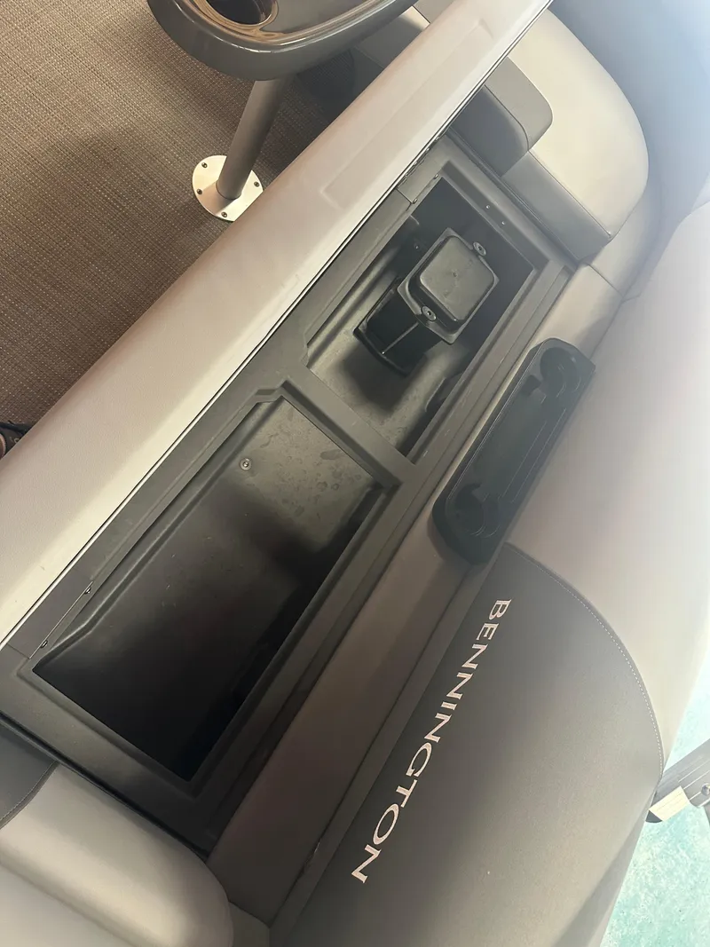 Slide: The Image of 2024 Bennington 20SVLSR boat interior with storage compartment and cup holder. - 29
