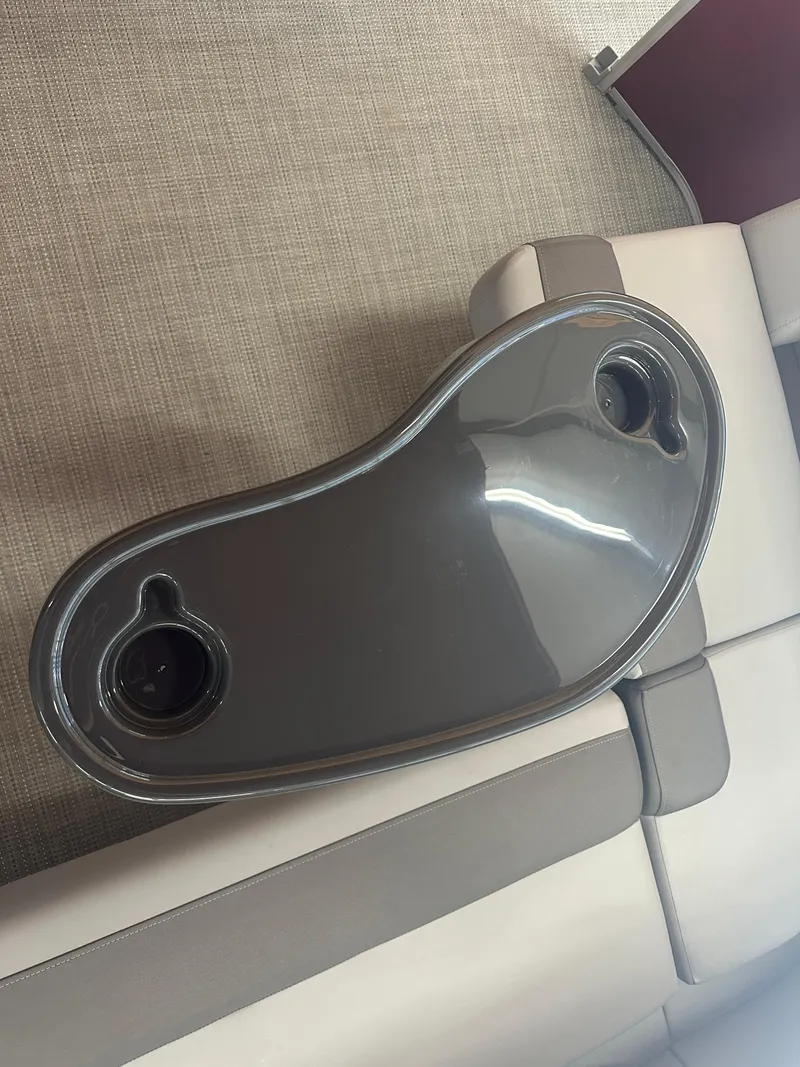 Slide: The Image of 2024 Bennington 20SVLSR boat interior with sleek table and cup holders. - 30