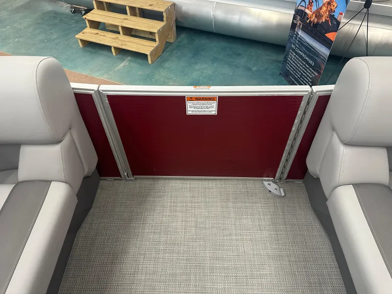 Slide: The Image of 2024 Bennington 20SVLSR boat interior with seating and safety warning sign. - 33
