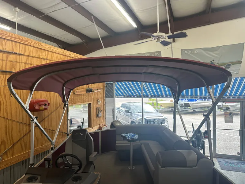 Slide: The Image of 2024 Bennington 20SVLSR pontoon boat interior with canopy in showroom. - 34