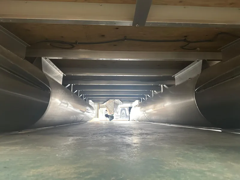 Slide: The Image of Underneath view of 2024 Bennington 20SVLSR pontoon boat, showcasing aluminum pontoons and structure. - 41
