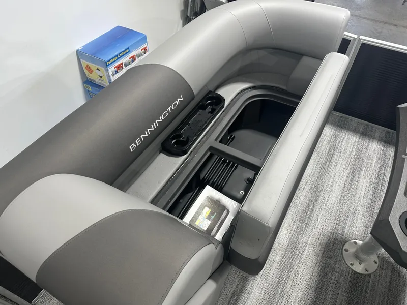 Slide: The Image of 2025 Bennington 22SSRSE boat interior with gray seating and storage compartment. - 15